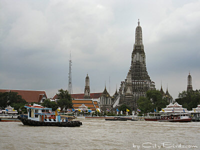 A Bangkok Buddhist Temple & River Boats in the Foreground