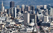 In this view of San Francisco, we see the TransAmerica Pyramid in the upper-left corner, the dome of City Hall is to the left, slightly below center, the tower of the Ferry Building is seen upper right of center and the United States Mint is seen in the center of the picture's foreground.  Photographed using a Canon SX40 HS camera. 